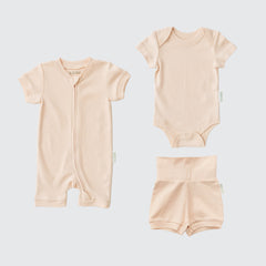 Rosy peach organic cotton baby outfit set with short sleeve romper, short sleeve bodysuit, and fold-over shorts.