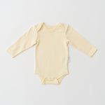 Organic cotton baby long sleeve bodysuit in sunny yellow
