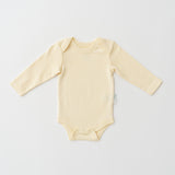 Organic cotton baby long sleeve bodysuit in sunny yellow