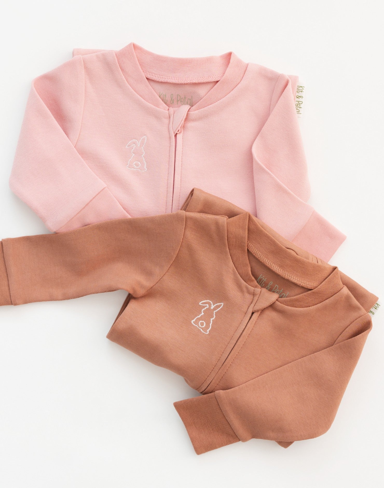 Long sleeve rompers in pink and brown with bunny embroidery on the chest