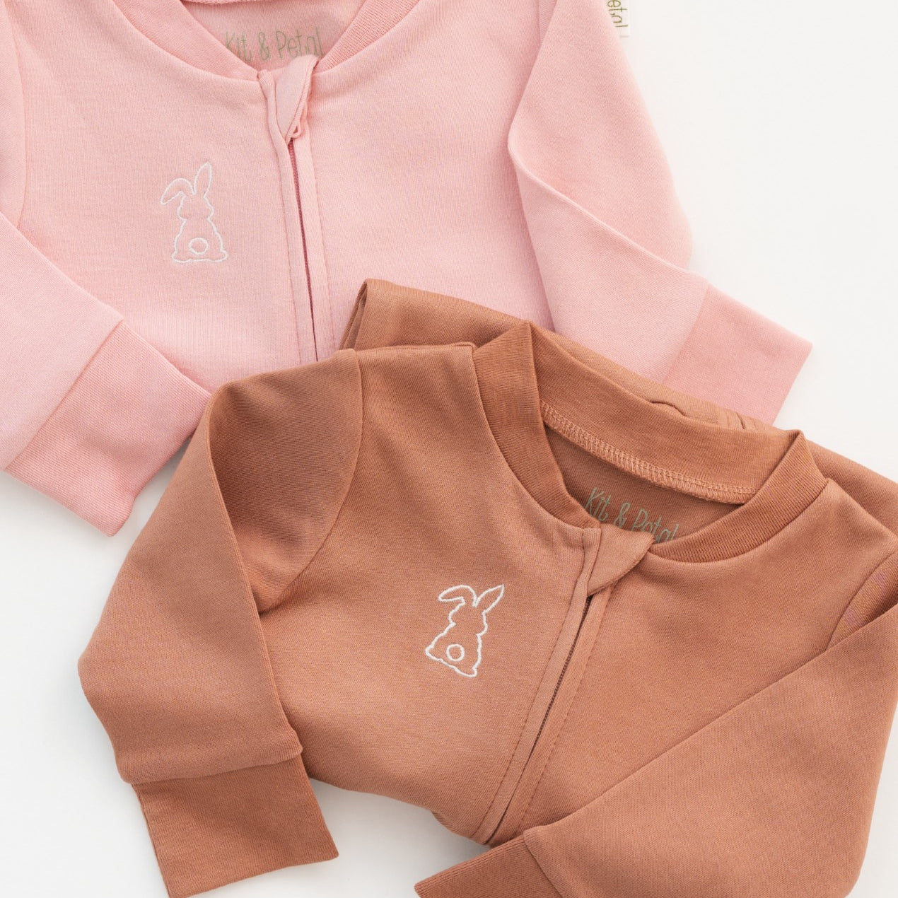 Folded long sleeve rompers in pink and brown with bunny embroidery on the chest