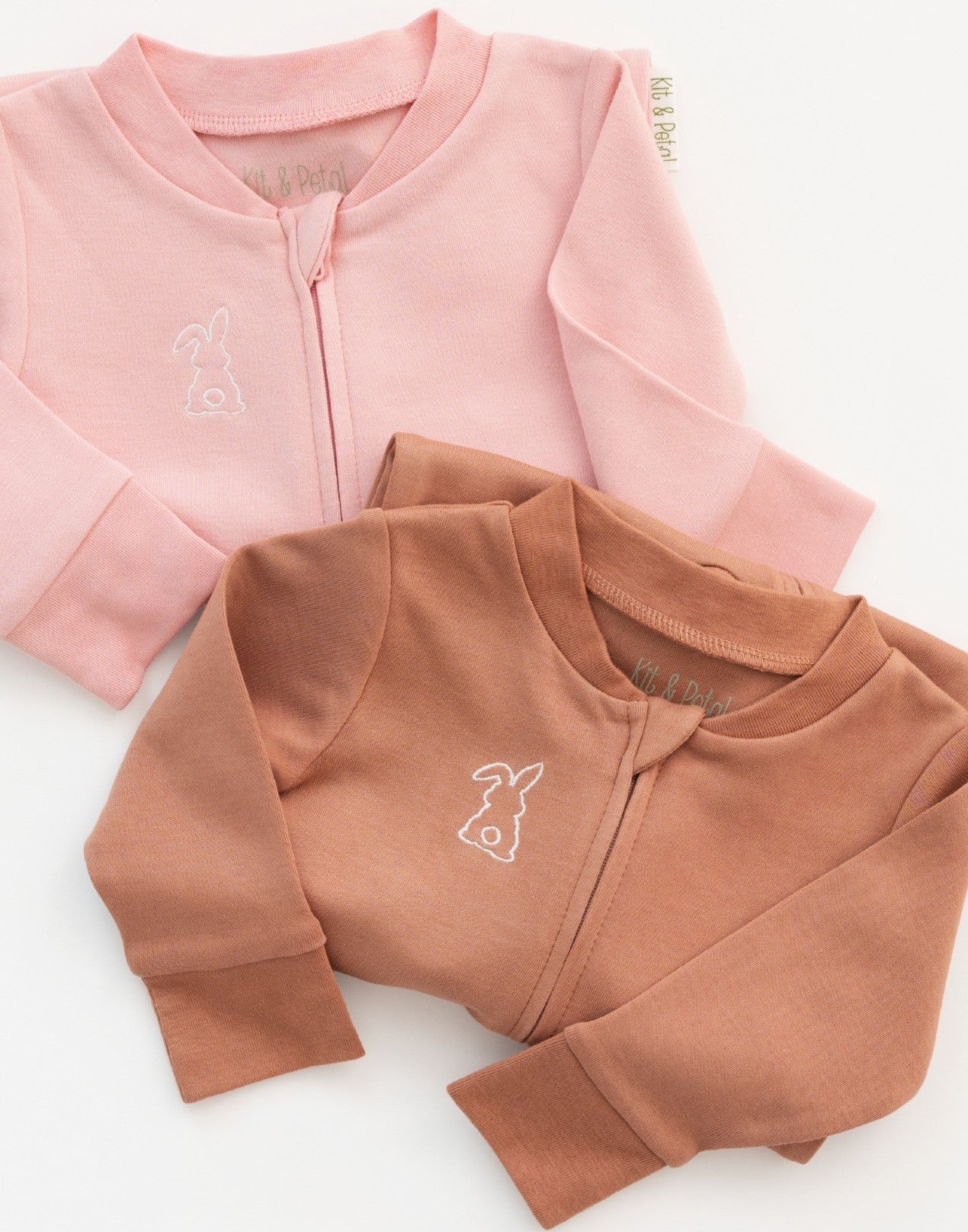 Folded long sleeve rompers in pink and brown with bunny embroidery on the chest