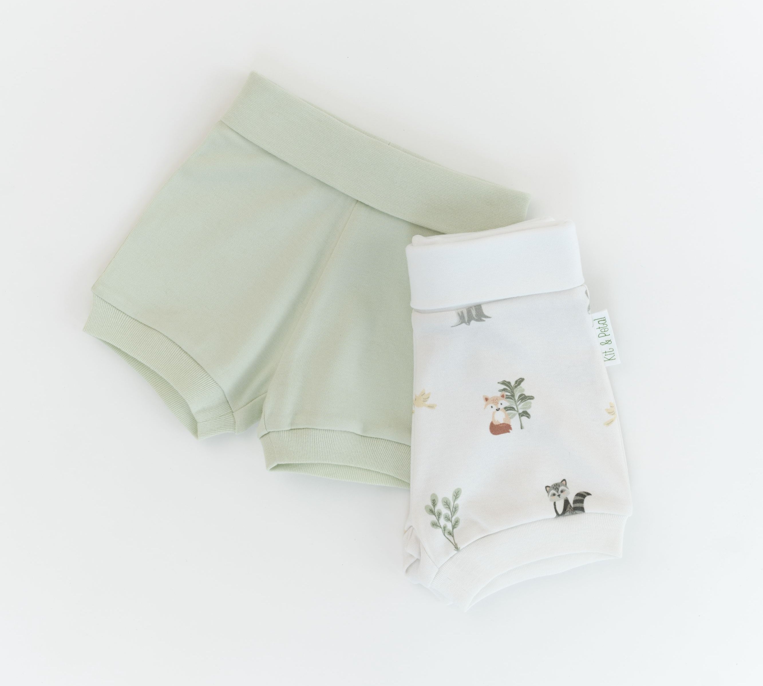Organic cotton baby fold-over shorts in leafy green and forest friends animal print
