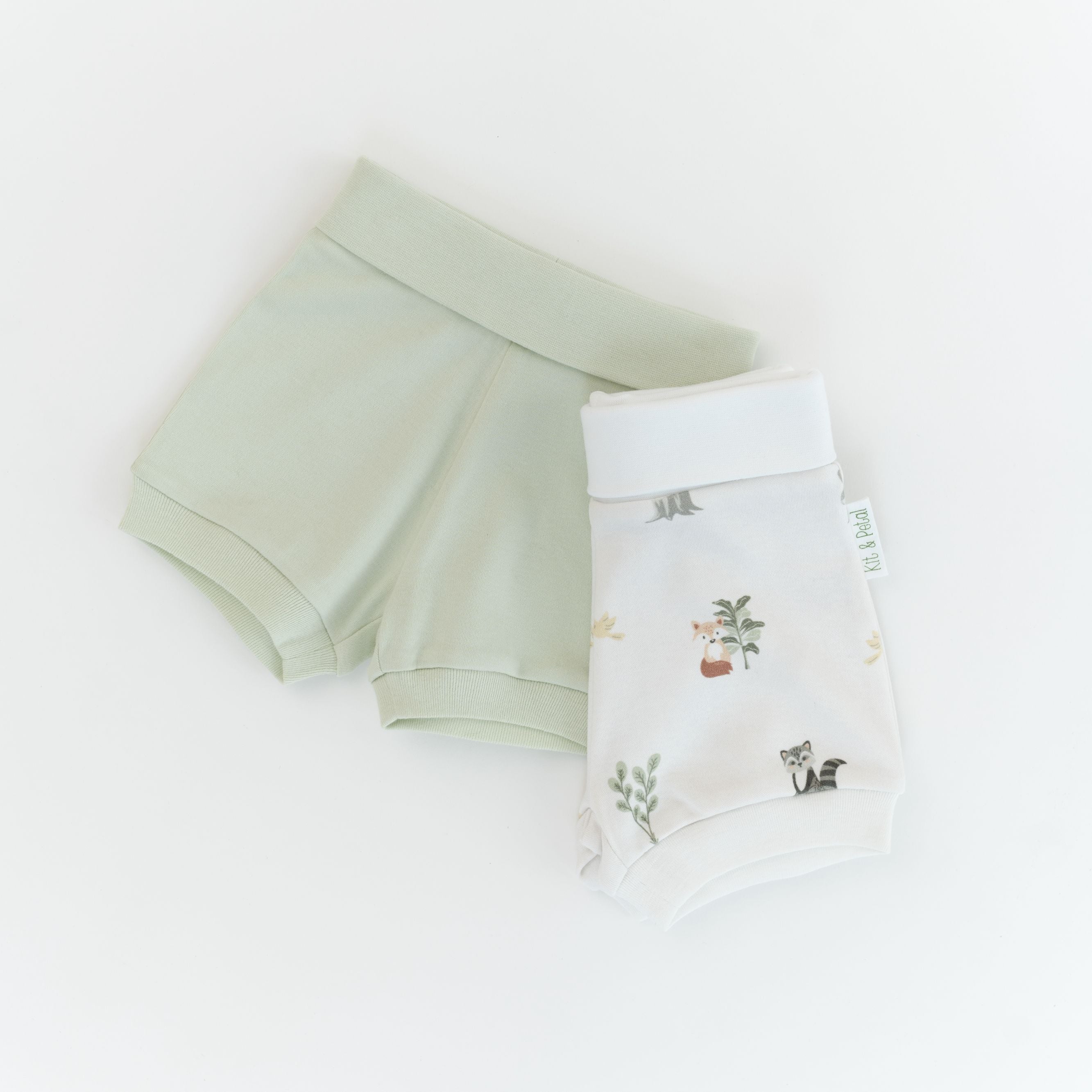 Organic cotton baby fold-over shorts in leafy green and forest friends animal print