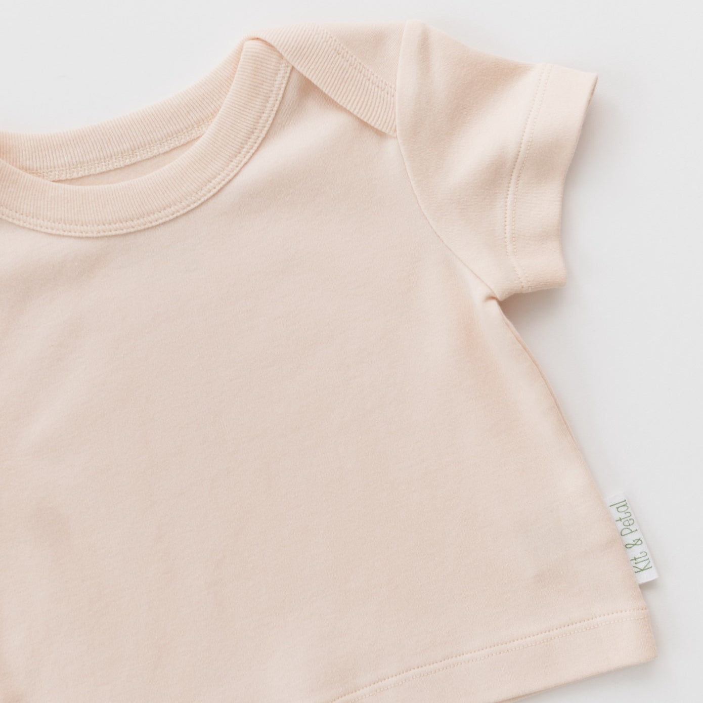 Rosy peach shirt on a diagonal on a white background