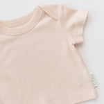 Rosy peach shirt on a diagonal on a white background