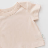 Rosy peach shirt on a diagonal on a white background