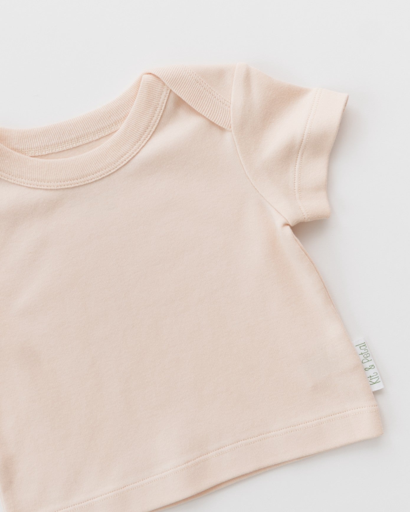 Rosy peach shirt on a diagonal on a white background