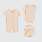 Rosy peach organic cotton baby outfit set with short sleeve romper, short sleeve bodysuit, and fold-over shorts.