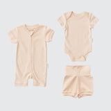 Rosy peach organic cotton baby outfit set with short sleeve romper, short sleeve bodysuit, and fold-over shorts.