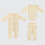 Sunny yellow organic cotton baby outfit set with long sleeve romper, long sleeve bodysuit, and fold-over pants.