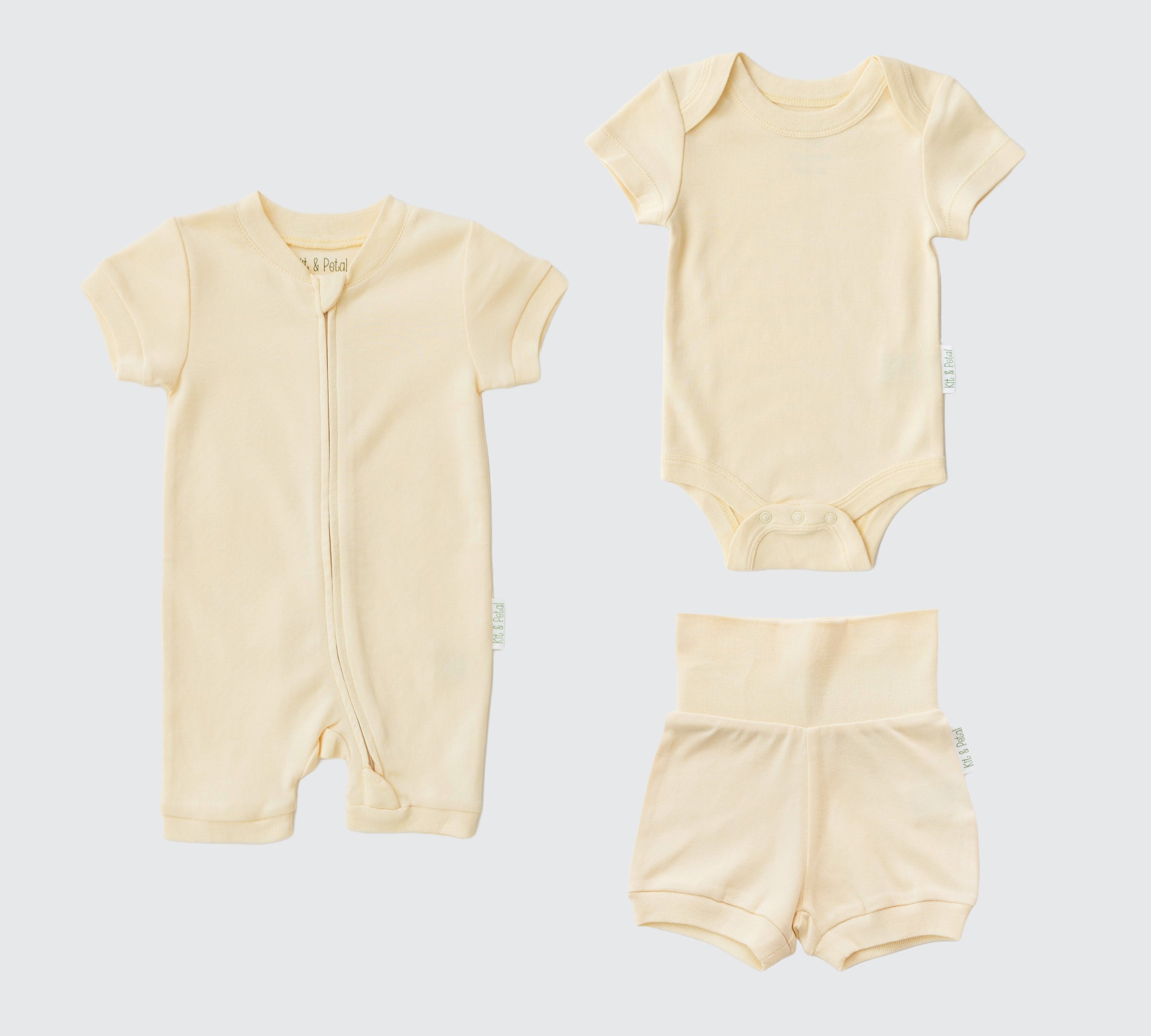 Sunny yellow organic cotton baby outfit set with short sleeve romper, short sleeve bodysuit, and fold-over shorts.